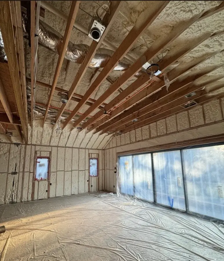 Interior walls and ceiling insulated with spray foam during new construction in Pella